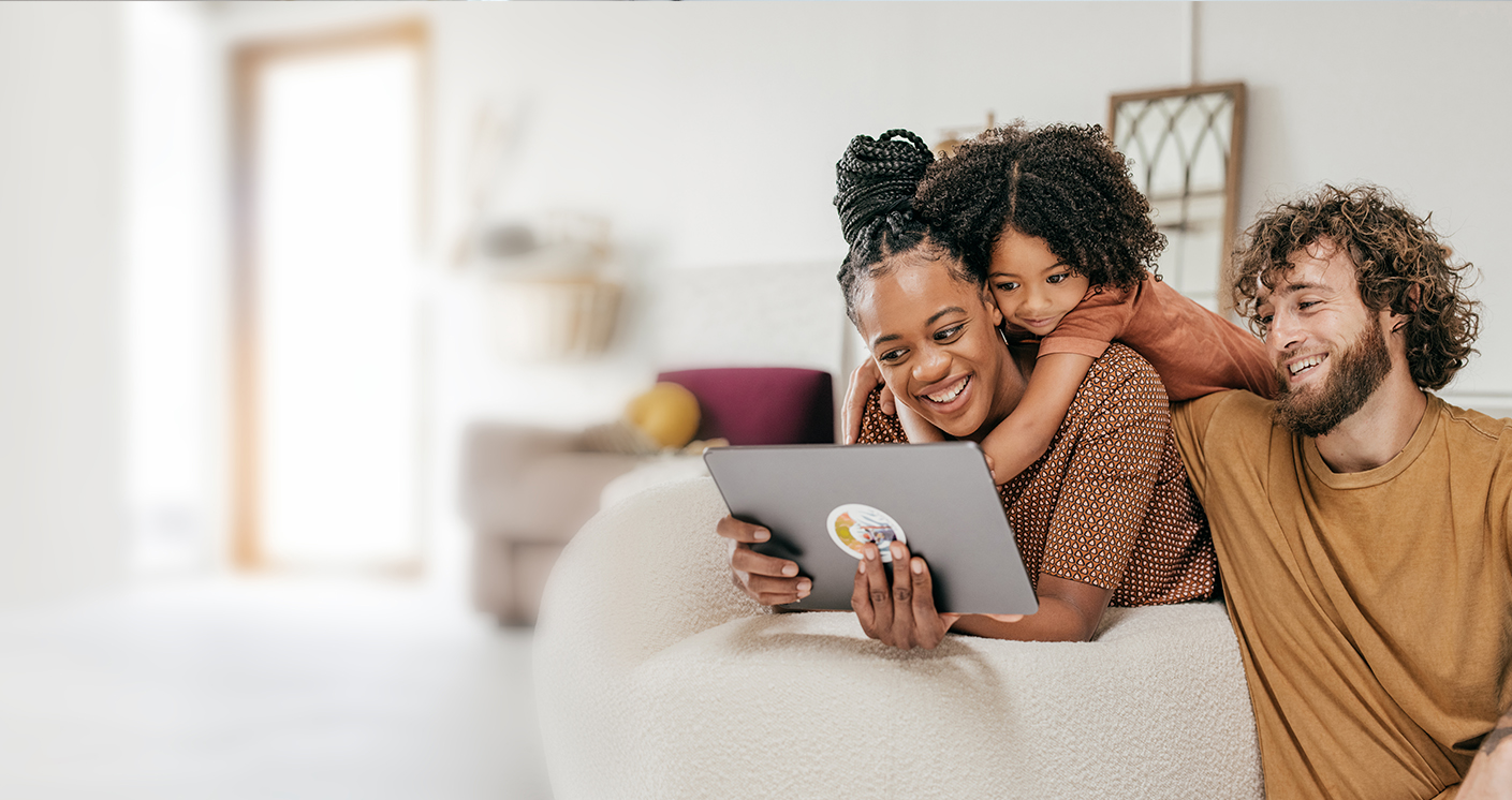 A family of three looking at an iPad screen