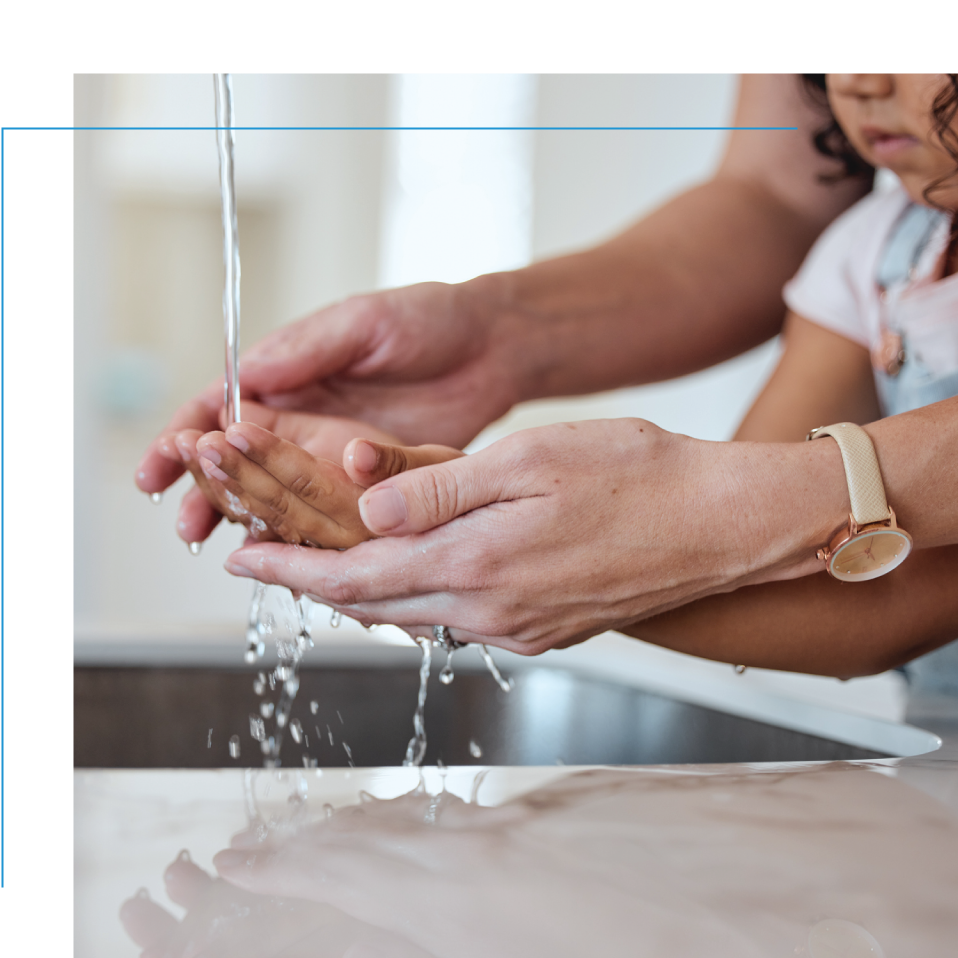 An adult and child washing their hands